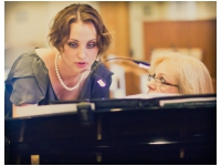 Jenn gives Andrea instructions at the piano