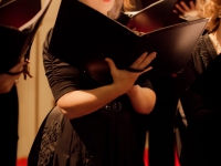 A chorus member sings during the concert